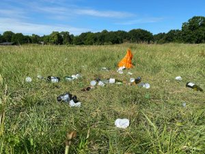 orange and white textile on green grass field during daytime